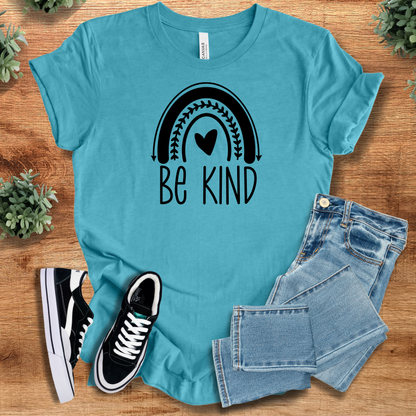 Heather-mauve t-shirt with '' text, flat lay styled on a wooden surface.