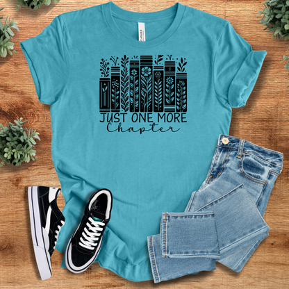 Heather-mauve t-shirt with '' text, flat lay styled on a wooden surface.