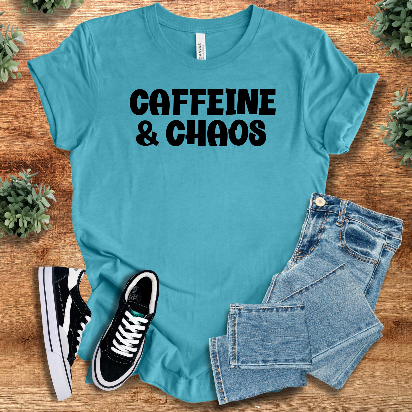 Heather-navy t-shirt with '' text, flat lay styled on a wooden surface.