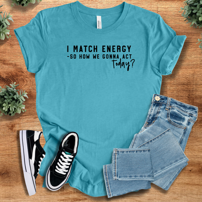 Heather-navy t-shirt with '' text, flat lay styled on a wooden surface.