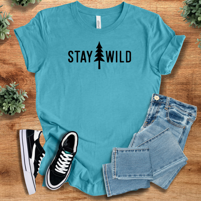 Heather-navy t-shirt with '' text, flat lay styled on a wooden surface.