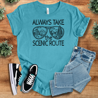 Heather-mauve t-shirt with '' text, flat lay styled on a wooden surface.