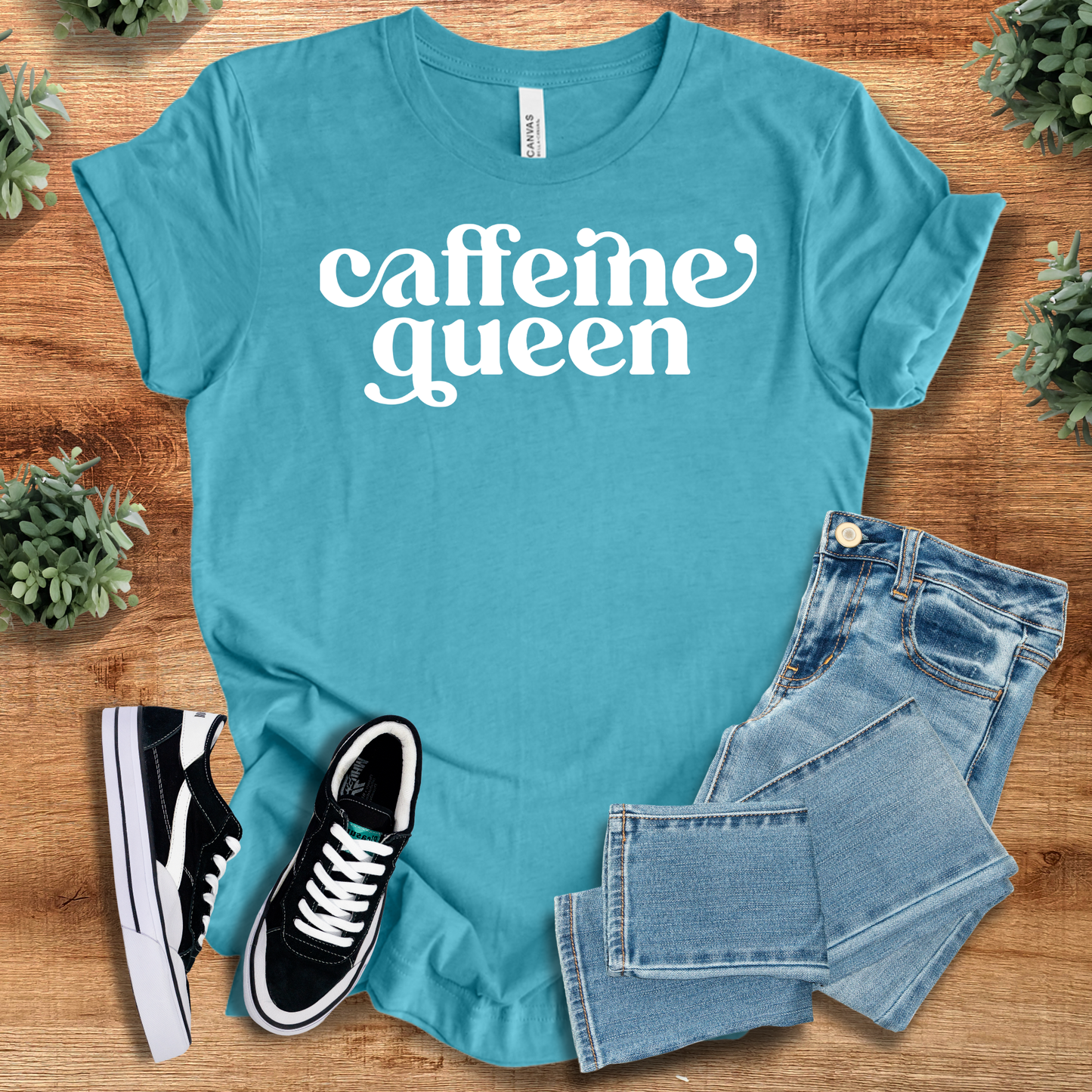 Caffeine Queen - Coffee Lovers T-Shirt in teal blue with white print. Comfortable cotton shirt styled with jeans and sneakers for casual looks.
