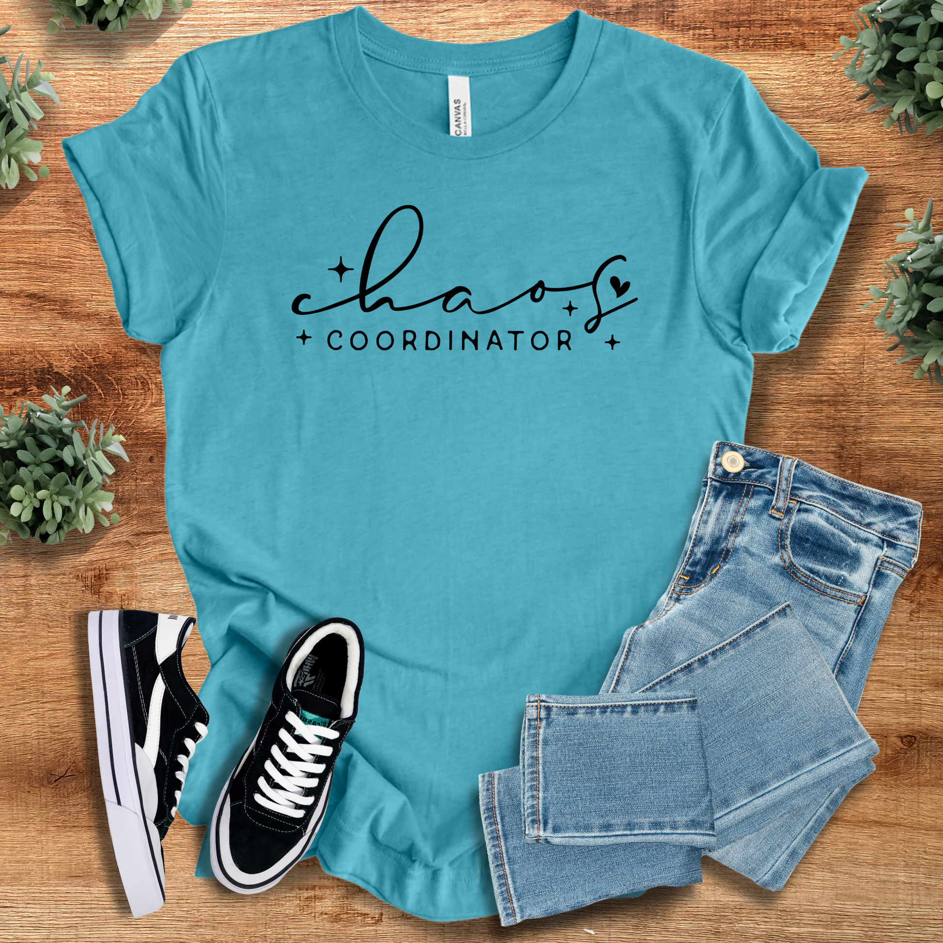 Heather-navy t-shirt with '' text, flat lay styled on a wooden surface.