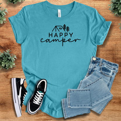 Heather-aqua t-shirt with 'Happy Camper Tee T‑Shirt' text, flat lay styled on a wooden surface.