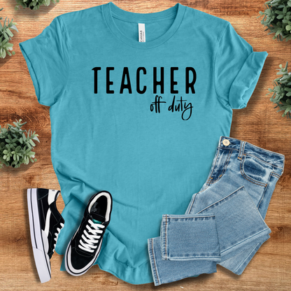 Heather-navy t-shirt with '' text, flat lay styled on a wooden surface.