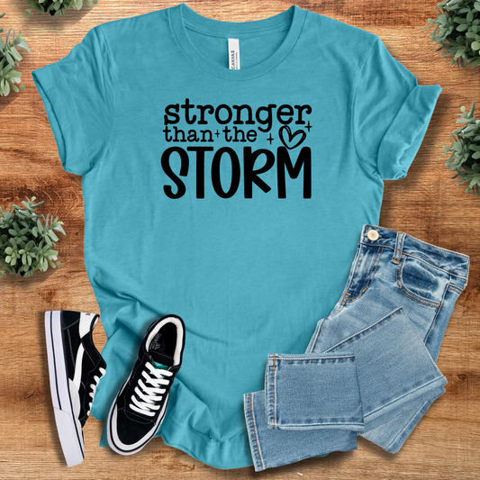 Stronger Than the Storm T-Shirt in teal with bold black text, 100% cotton inspirational wear for casual and mental health awareness events.