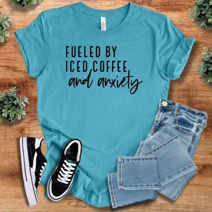 Heather-mauve t-shirt with '' text, flat lay styled on a wooden surface.