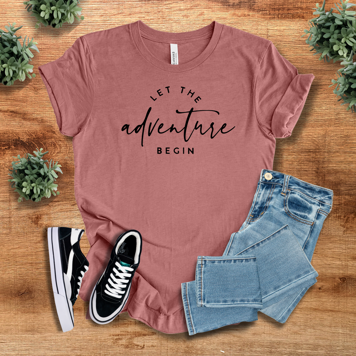 Mauve 'Let The Adventure Begin' t-shirt styled with denim jeans and sneakers. A trendy and comfortable tee for casual fashion.