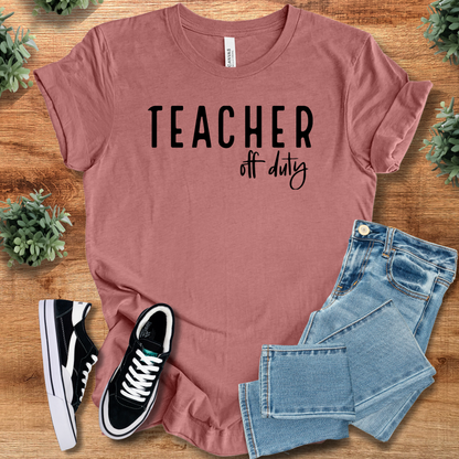 Heather-navy t-shirt with '' text, flat lay styled on a wooden surface.