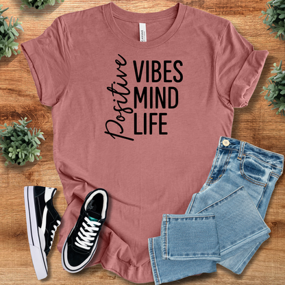 Heather-navy t-shirt with '' text, flat lay styled on a wooden surface.
