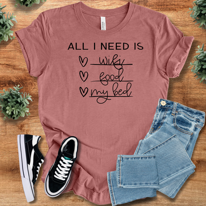 Yellow t-shirt with '' text, flat lay styled on a wooden surface.
