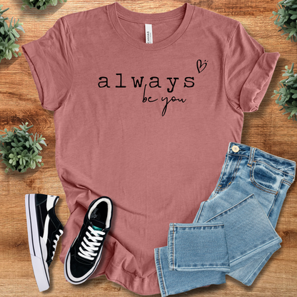 Heather-aqua t-shirt with '' text, flat lay styled on a wooden surface.