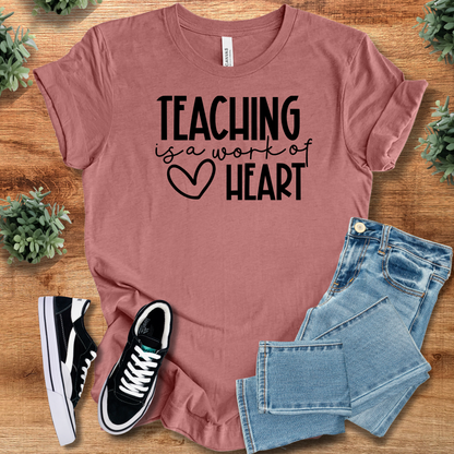 Heather-aqua t-shirt with '' text, flat lay styled on a wooden surface.