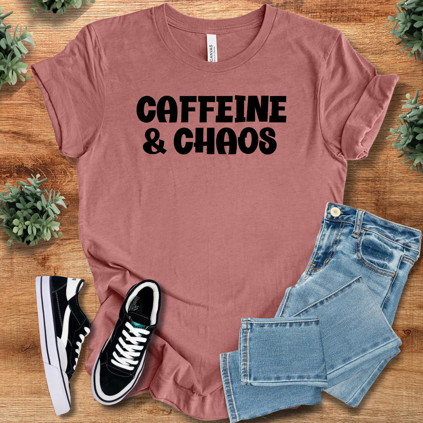 Heather-navy t-shirt with '' text, flat lay styled on a wooden surface.