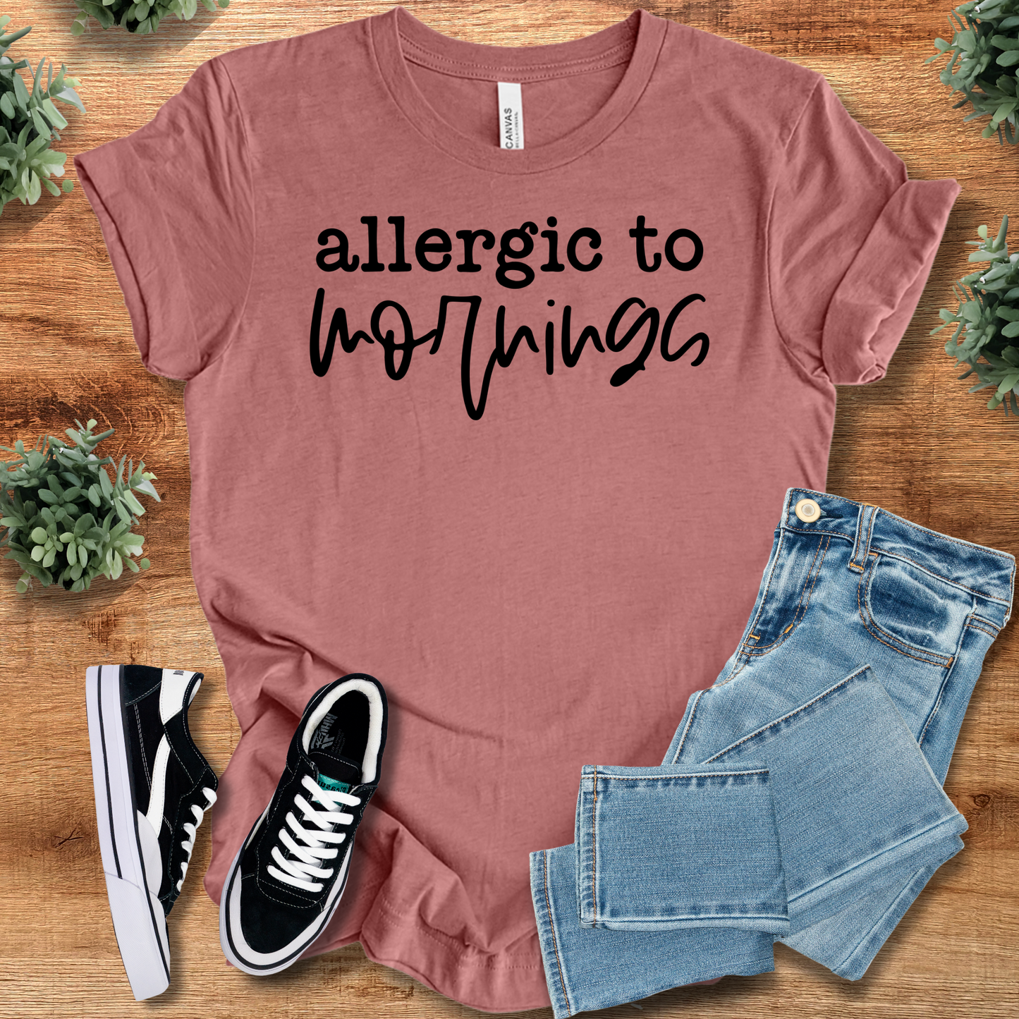 Athletic-heather t-shirt with '' text, flat lay styled on a wooden surface.