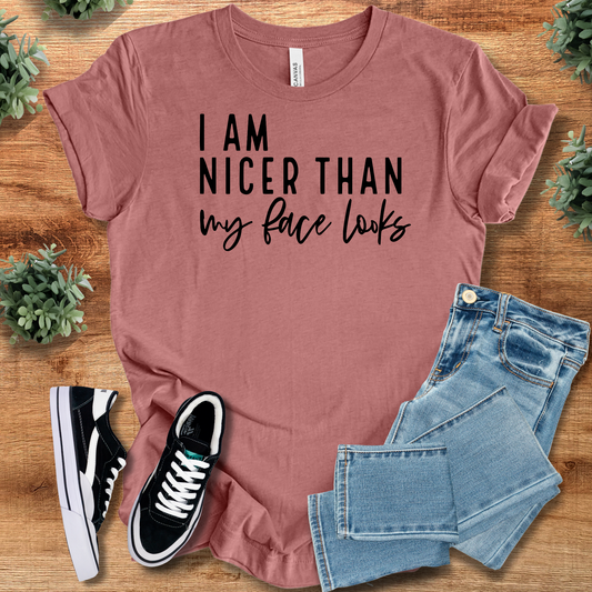 Humor T-Shirt Casual Wear in mauve with 'I'm Nicer Than My Face Looks' text. 100% cotton tee styled with jeans and sneakers.