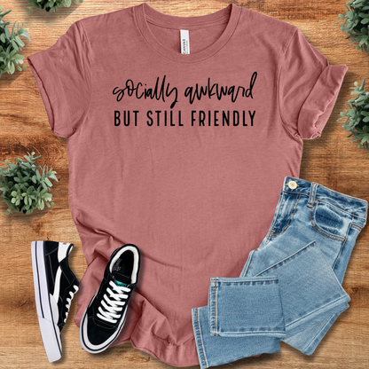 Heather-navy t-shirt with '' text, flat lay styled on a wooden surface.