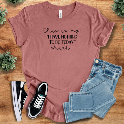 Yellow t-shirt with '' text, flat lay styled on a wooden surface.