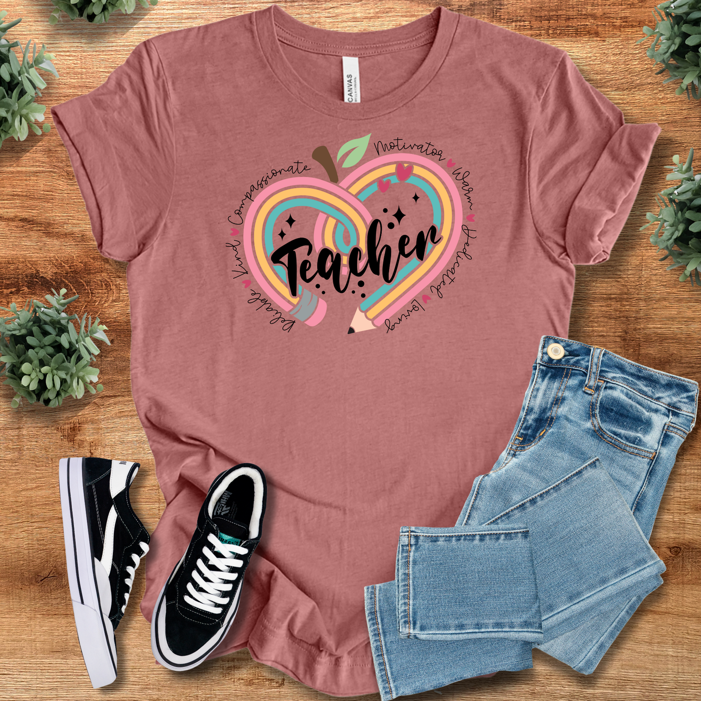 Mauve Teacher Appreciation T-Shirt with multicolor apple-heart graphic and uplifting text. Comfortable cotton top for educators and mentors.