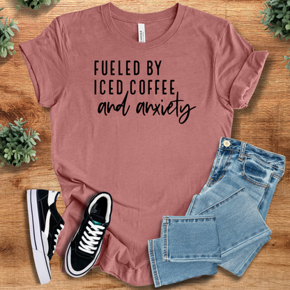 Heather-aqua t-shirt with '' text, flat lay styled on a wooden surface.