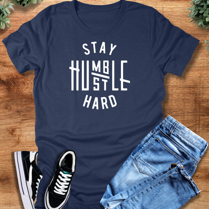 Black t-shirt with '' text, flat lay styled on a wooden surface.