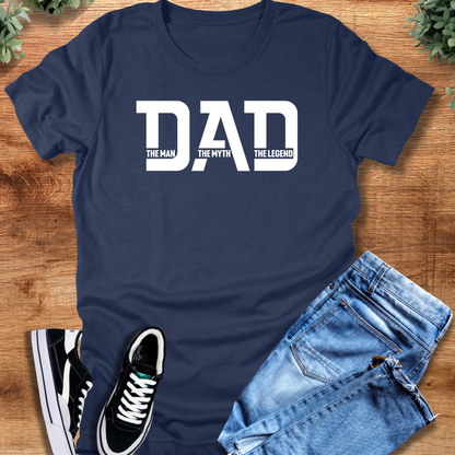 White t-shirt with '' text, flat lay styled on a wooden surface.