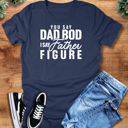 White t-shirt with '' text, flat lay styled on a wooden surface.