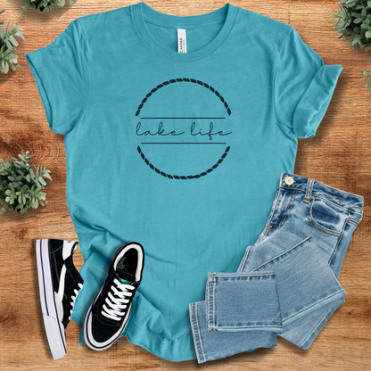 Heather-navy t-shirt with '' text, flat lay styled on a wooden surface.