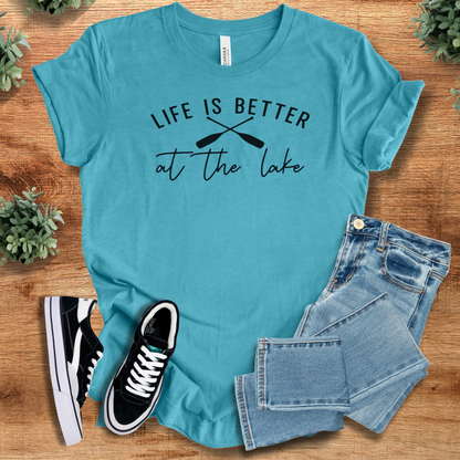 Heather-navy t-shirt with '' text, flat lay styled on a wooden surface.