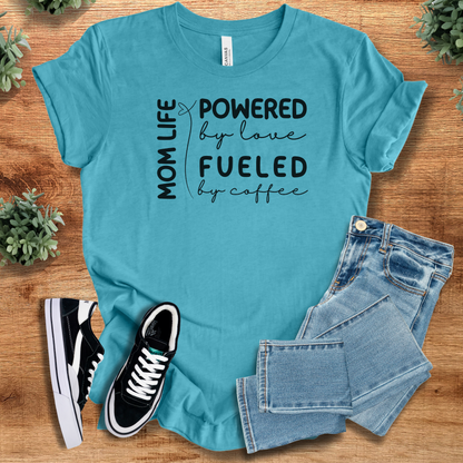 Heather-aqua t-shirt with 'Mom Life T‑Shirt' text, flat lay styled on a wooden surface.