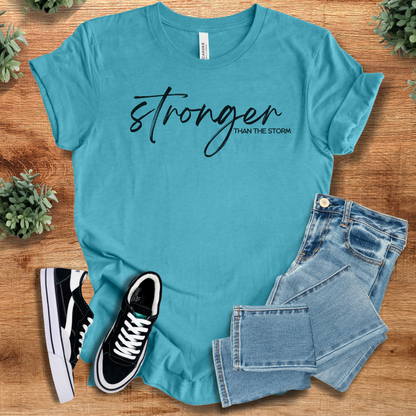 Heather-navy t-shirt with '' text, flat lay styled on a wooden surface.