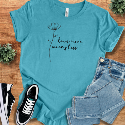Heather-mauve t-shirt with '' text, flat lay styled on a wooden surface.