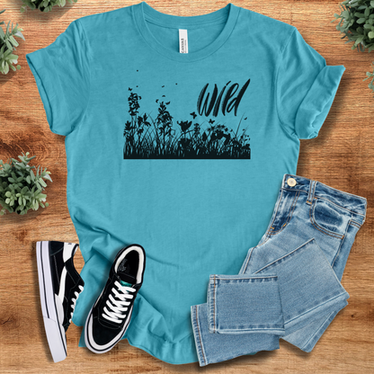 Heather-mauve t-shirt with '' text, flat lay styled on a wooden surface.