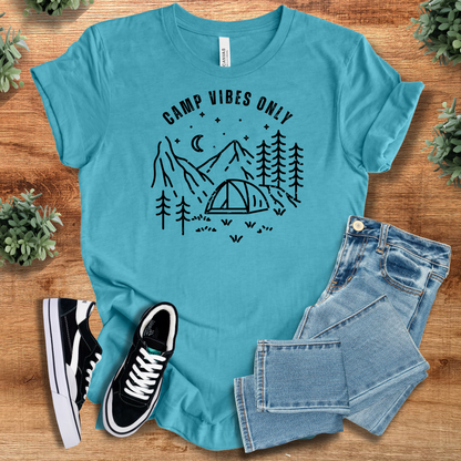 Heather-mauve t-shirt with '' text, flat lay styled on a wooden surface.