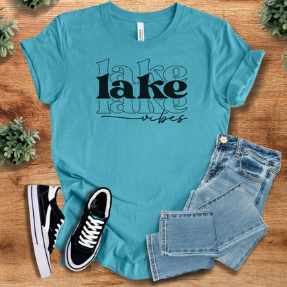 Heather-navy t-shirt with '' text, flat lay styled on a wooden surface.