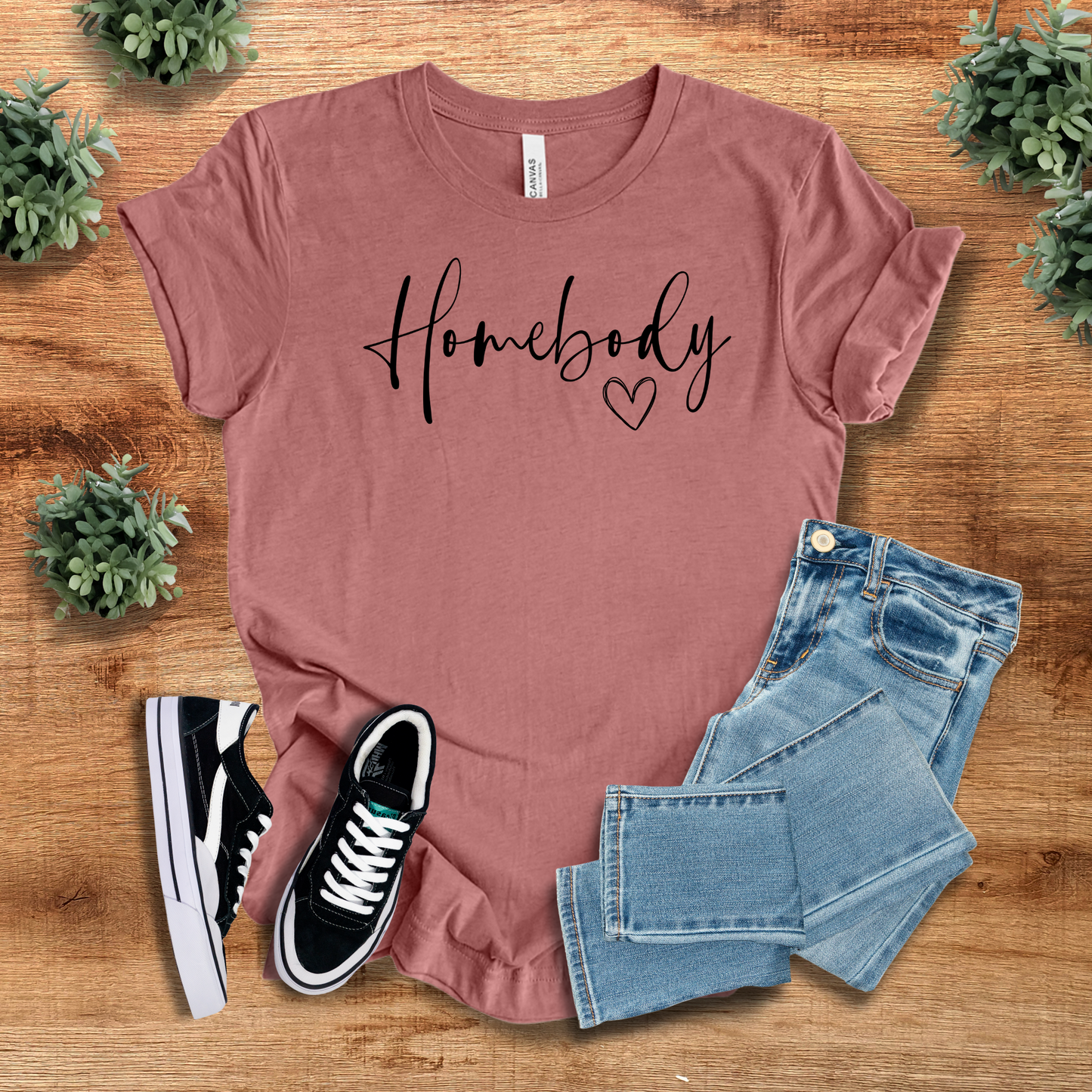 Mauve Homebody Graphic T-Shirt with a minimalist heart design, styled with jeans and sneakers. A soft and trendy tee for everyday comfort.