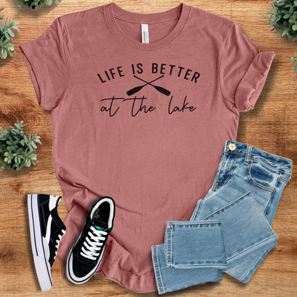 Heather-navy t-shirt with '' text, flat lay styled on a wooden surface.