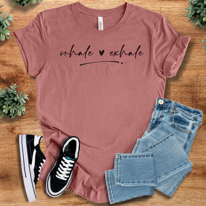 Heather-navy t-shirt with '' text, flat lay styled on a wooden surface.