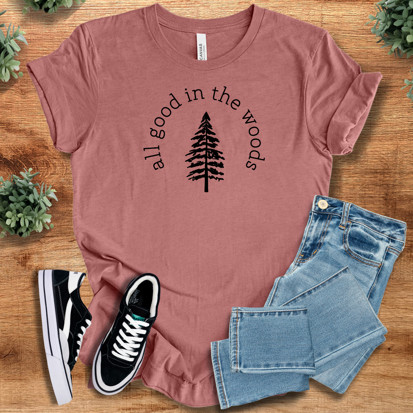 Heather-navy t-shirt with '' text, flat lay styled on a wooden surface.