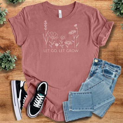 Yellow t-shirt with '' text, flat lay styled on a wooden surface.