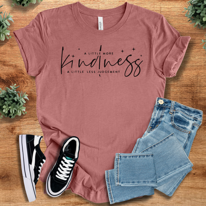Yellow t-shirt with '' text, flat lay styled on a wooden surface.