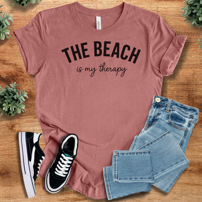 Heather-aqua t-shirt with '' text, flat lay styled on a wooden surface.