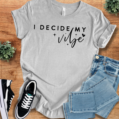 Heather-mauve t-shirt with '' text, flat lay styled on a wooden surface.