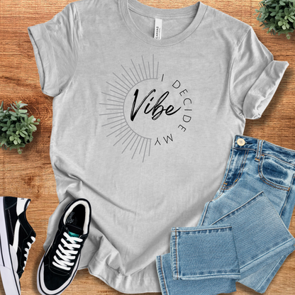 Athletic-heather t-shirt with 'I Decide My Vibe T‑Shirt' text, flat lay styled on a wooden surface.