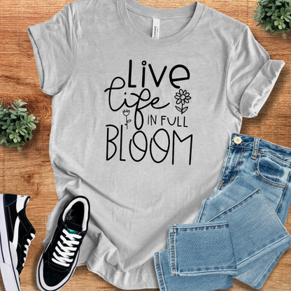 Heather-aqua t-shirt with '' text, flat lay styled on a wooden surface.