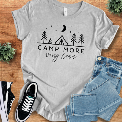 Athletic-heather t-shirt with 'Camp More Worry Less T‑Shirt' text, flat lay styled on a wooden surface.