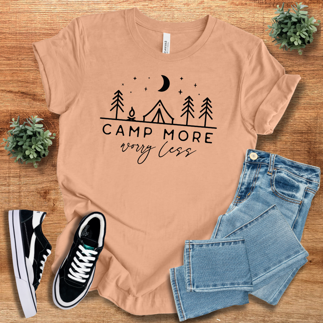 Peach 'Camp More Worry Less' t-shirt featuring a camping-themed design. A comfortable and trendy crew neck tee for outdoor adventures and relaxation.