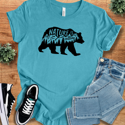 Heather-mauve t-shirt with '' text, flat lay styled on a wooden surface.