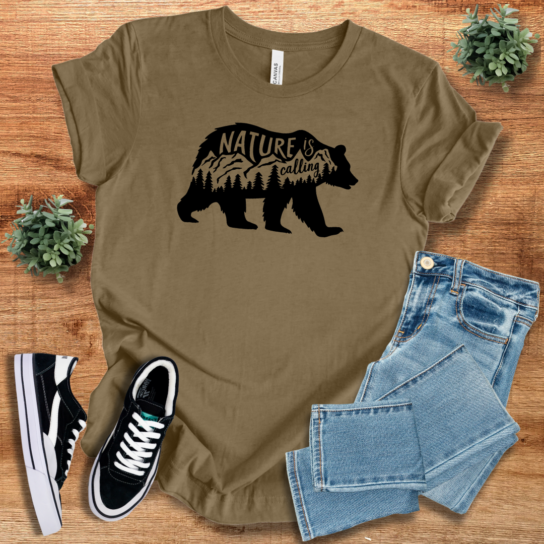 Brown 'Nature Is Calling' t-shirt with a black bear silhouette and mountain design. A perfect unisex casual tee for nature lovers and explorers.